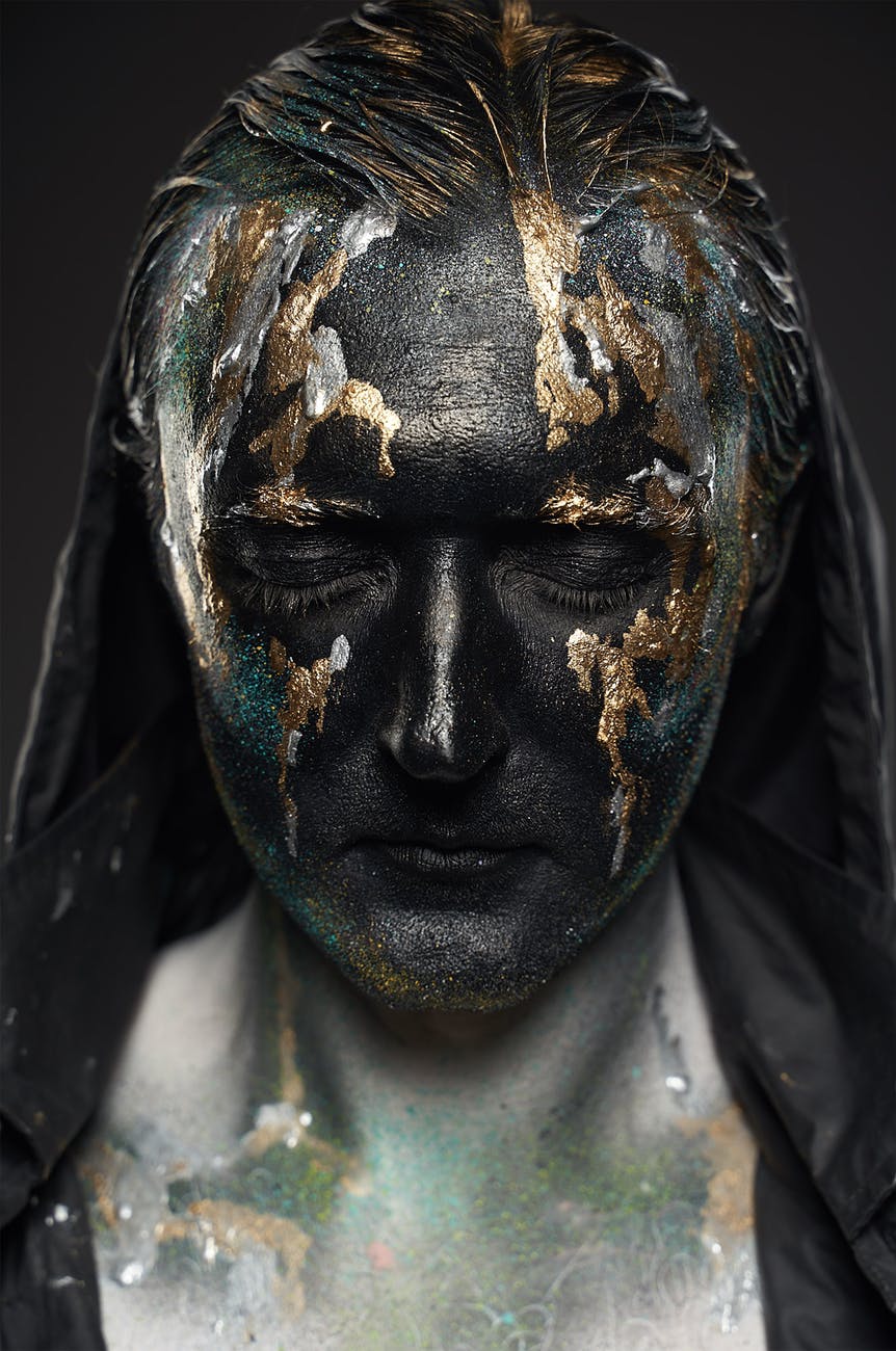 calm male with artistic make up and closed eyes