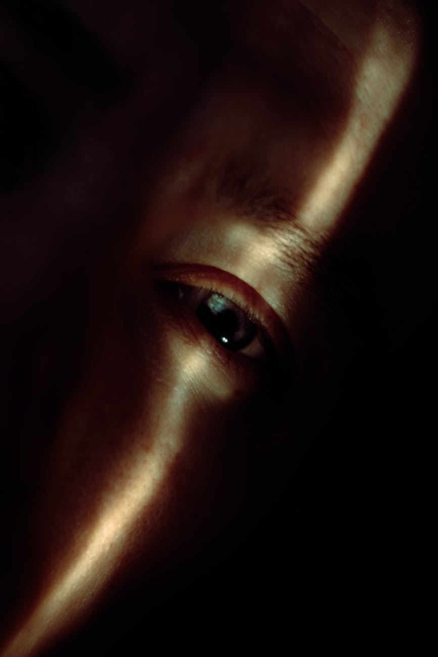 crop person with green eyes in sunlight